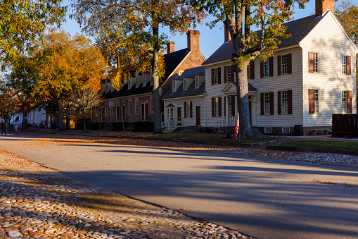 Colonial Williamsburg in Virginia, showcases row houses along a sunny autumnal street in the historic center