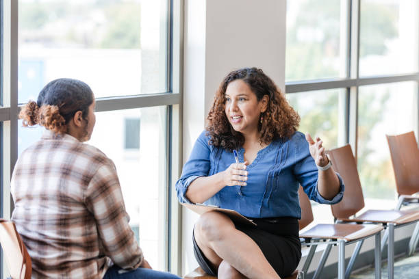 istock Mid adult female supervisor gestures while talking to her employee 1822947192