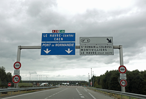 large road sign with French locations to go to the city of Le Havre or to the Normandy Bridge in Northern France