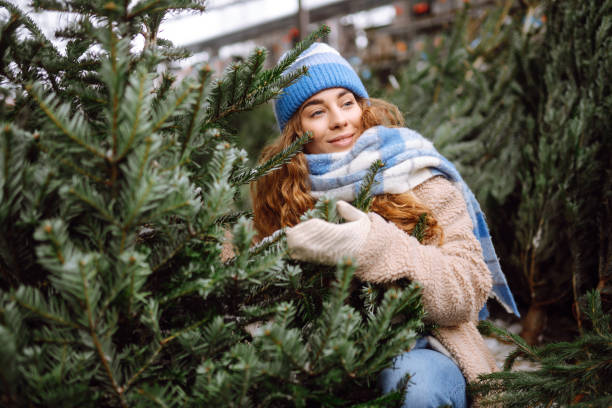 istock Happy woman buying a Christmas tree. 1822992424