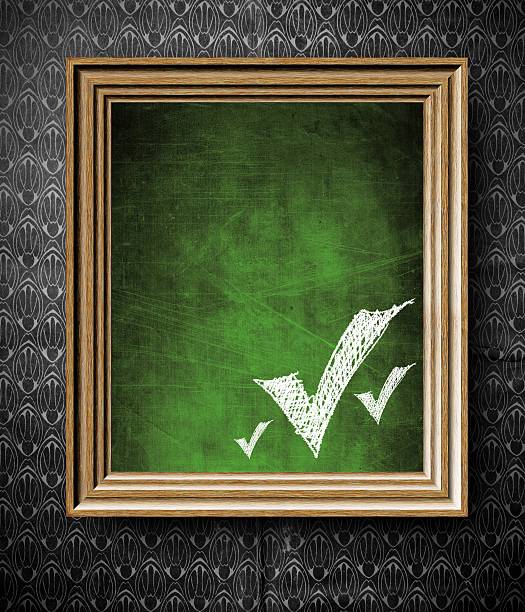 Check marks symbol with copy-space chalkboard in old wooden frame
