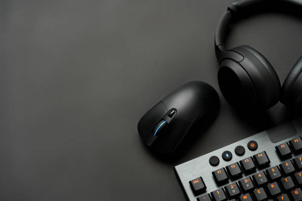 istock Headphones, computer mouse and keyboard on black background 1823018310