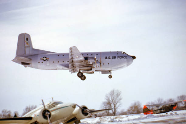 Korean and Vietnam era military cargo plane, Douglas C-124, landing on a snowy day. Built about 1950, photographed 1963. Scanned film.
