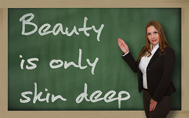 istock Teacher showing Beauty is only skin deep on blackboard 182303619