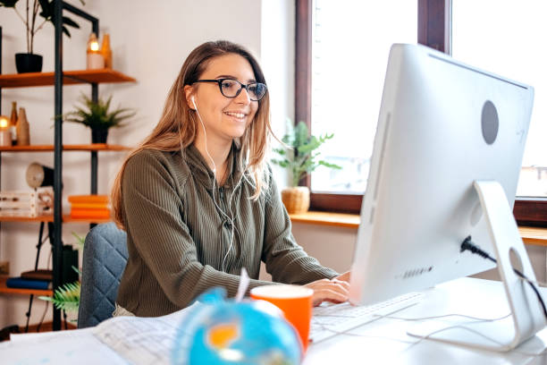 Young businesswoman having on line meeting at home using computer