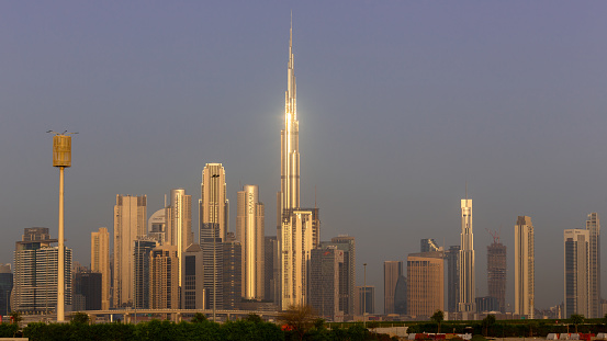 Dubai, UAE, 18.09.22. Dubai Downtown skyline landscape with the skyscrapers reflecting golden sun during sunrise.