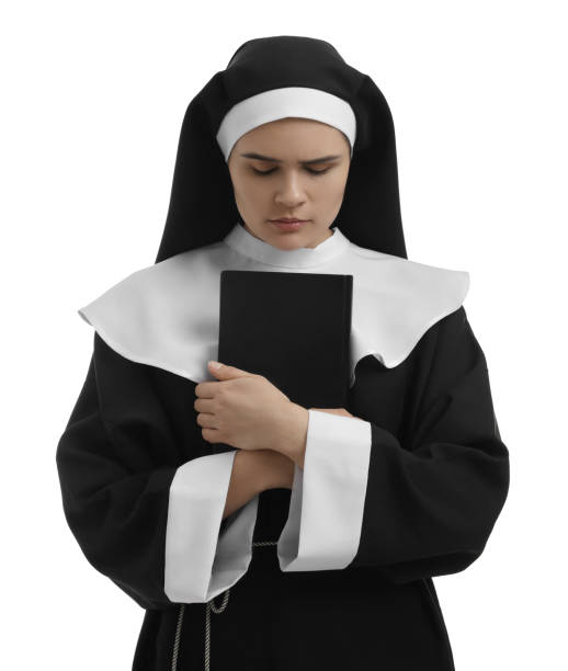 istock Young nun holding Bible on white background 1823058817