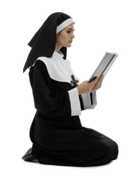istock Young nun reading Bible on white background 1823059370