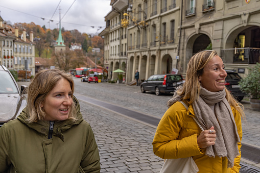 Female friends walking around the streets of medieval city of Bern, Switzerland