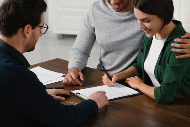 istock Notary helping couple with paperwork at wooden table, closeup 1823080084
