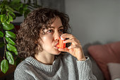 Woman with asthma inhaler