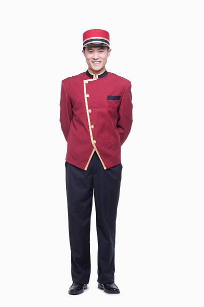 Portrait of Bellhop, full length, studio shot Portrait of Bellhop, full length, studio shot bellhop stock pictures, royalty-free photos & images