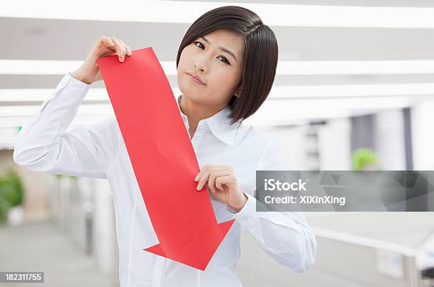 Young Woman Holding Arrow Sign Paper Cut Stock Photo - Download Image Now - Adult, Adults Only, Arrow Symbol
