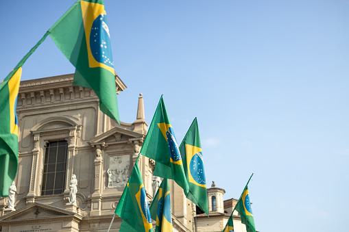 Brazilian flags waving. Official Federative Republic Brazil national flag at building