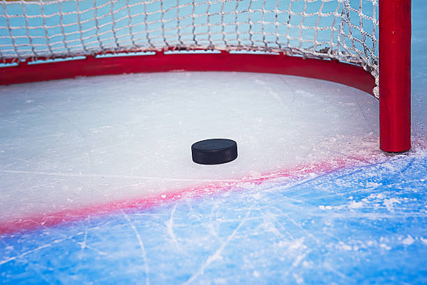 istock Hockey puck crossing goal line 182314664
