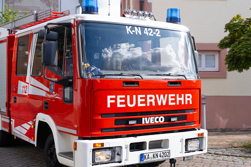 Emergency Situations, red fire truck driving city streets to extinguish fire, urban infrastructure and security services, Karlsdorf, Germany - October 15, 2023