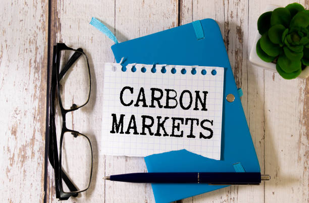istock Carbon markets symbol. notepad with clip. text on open notepad., Business and carbon markets concept, copy space 1823194869