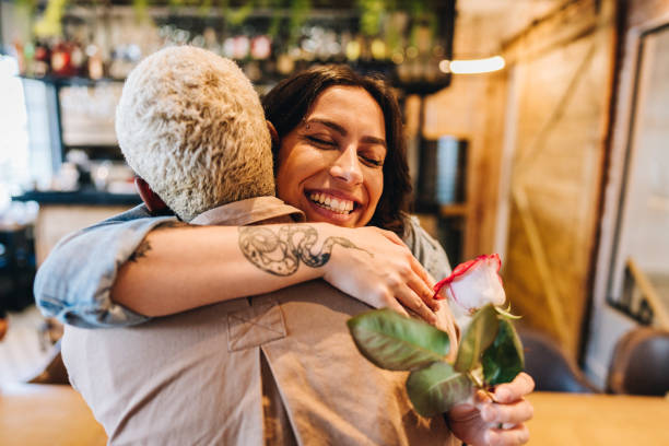 Lesbian couple embracing at coffee shop