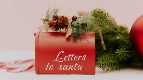 istock Santa Claus mailbox with fir branches and Christmas decor on light pink. 1823234297