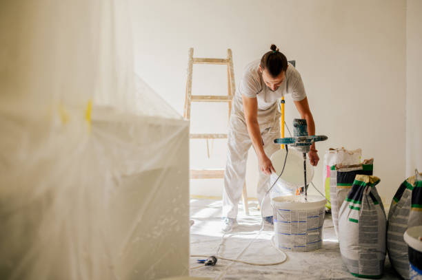 istock A laborer is adding water to a plaster mixture while renovating home. 1823240168