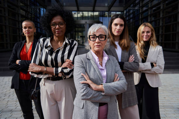 confident group of multiethnic businesswomen looking at camera seriously. - generation gap imagens e fotografias de stock