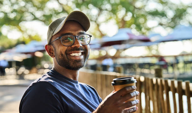 istock Smiling young man drinking coffee at a wildlife reserve rest stop 1823310937
