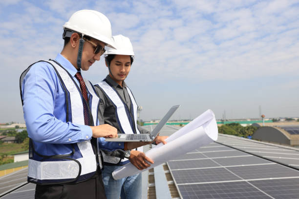 istock Solar Energy project management and Engineer energy power work as a blueprint equipment construction and laptop at photovoltaic panels on solar roofs with the concept of renewable and Sustainable energy and its service. 1823327274