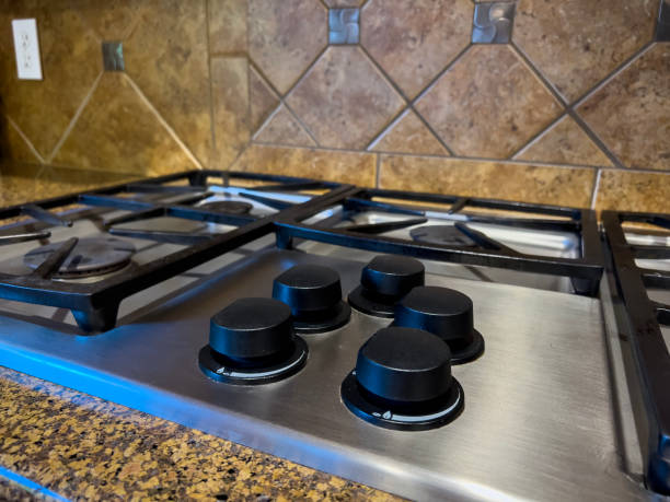 istock view of a beautiful gas stove top with black knobs against a square tiled backsplash 1823338817