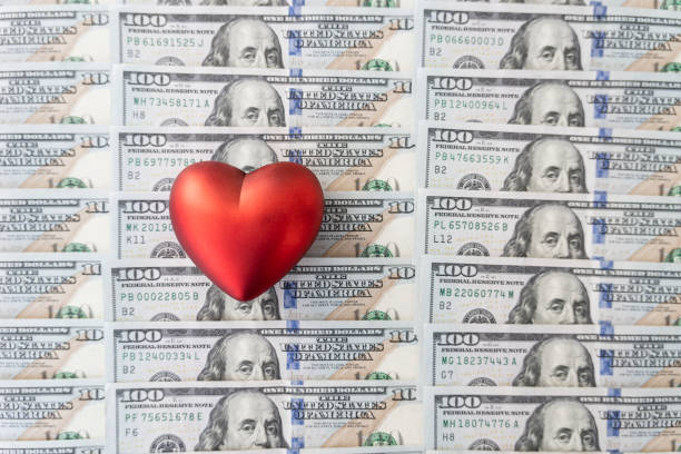 Heart shape sign with 100 dollars banknotes. Valentine concept background. Heart of banknotes in 100 dollars. Place for text. copy space. the form, blank for design. copyspace. love of money Heart shape sign with 100 dollar banknotes. Valentine concept background. Heart and banknotes in 100 dollars. Place for text. copy space. the form, blank for design. copy space. love of money valentinstag stock pictures, royalty-free photos & images