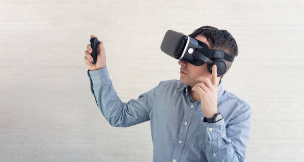 istock man wearing virtual reality headset or goggles on white background, looking around, excited by participation effect, watching 3d movie, vr for phone and mobile gaming 1823393606