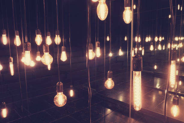 istock Vintage light bulbs hanging on the ceiling, retro color tone. 1823402626