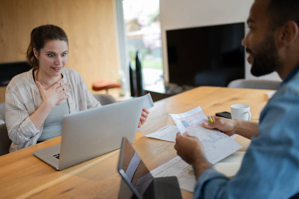 istock Multiracial couple paying bills online 1823404427