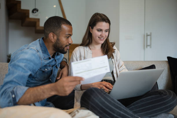 istock Multiracial couple paying bills online 1823404955