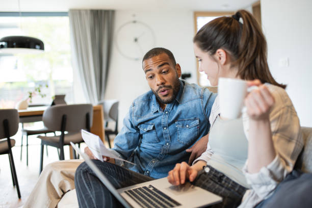 istock Multiracial couple paying bills online 1823404963