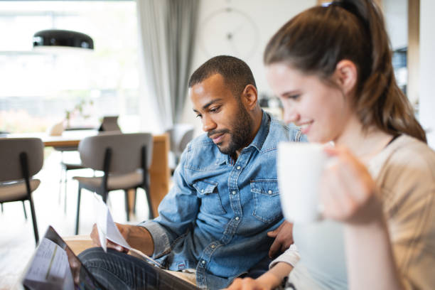 istock Multiracial couple paying bills online 1823404966