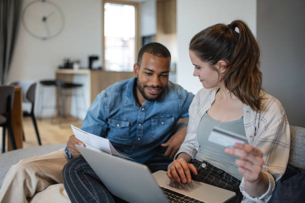 istock Multiracial couple paying bills online 1823404979
