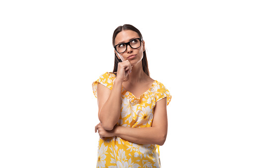 young pretty brunette lady wears glasses for vision correction.