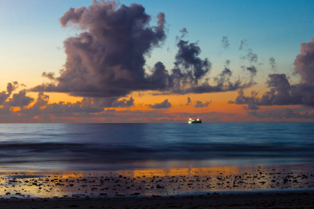Indian Rocks Beach, Florida, USA - People enjoying beautiful sunset at sandy beach