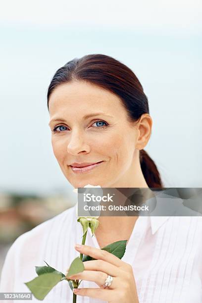 Smiling Mid Adult Lady Holding A Flower Stock Photo - Download Image Now - 30-39 Years, 35-39 Years, Adult