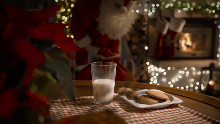 Santa Claus bringing gifts, eating ginger cookies with milk