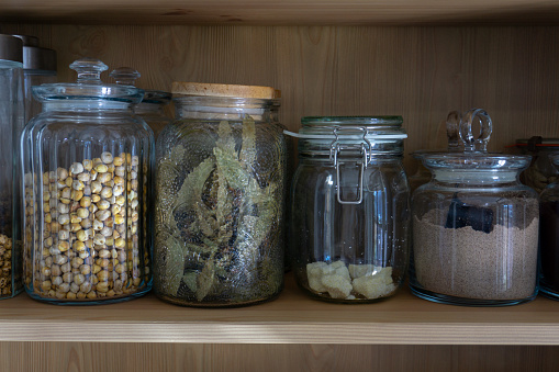 Jars of legumes on the shelf. Kitchen ingredients in jar. Kitchen cabinet layout.