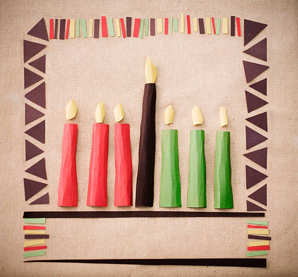 Pieces of paper cut out and placed on paper to make candles A paper craft Kwanzaa kinara. kwanzaa stock pictures, royalty-free photos & images