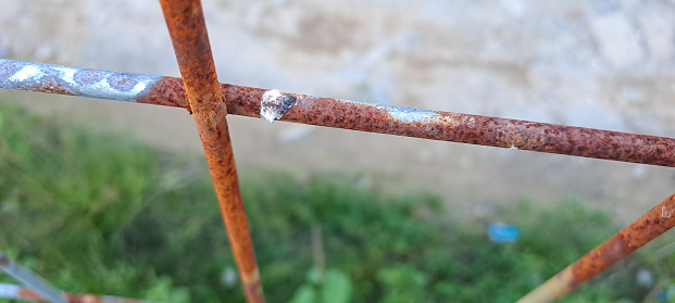 Close up of old and rusty iron fence