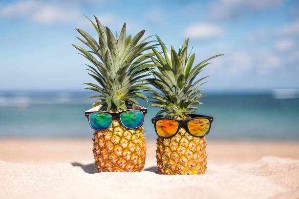 istock Two pineapples with trendy sunglasses in tropical paradise 1823518986