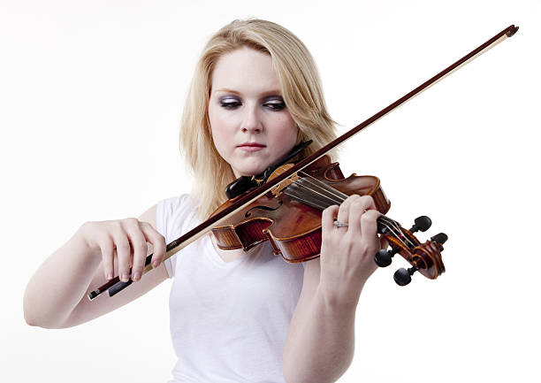 istock young woman playing violin 182352246