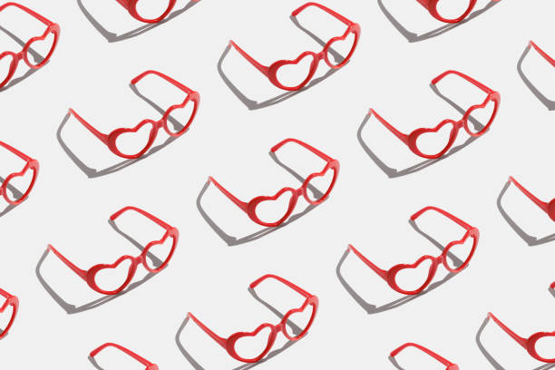 istock Pattern made with red heart shaped sunglasses on pastel color background 1823525896