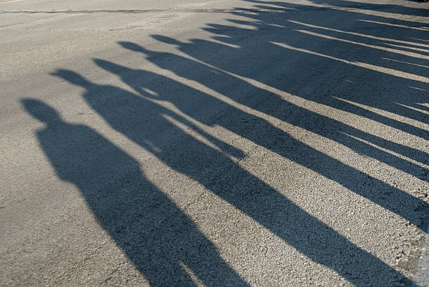 istock Shadows of People Lining a Morning Parade Route 182353022