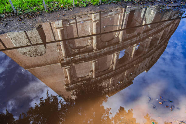 le colisée se reflète sur une flaque d’eau - puddle rome reflection street photos et images de collection