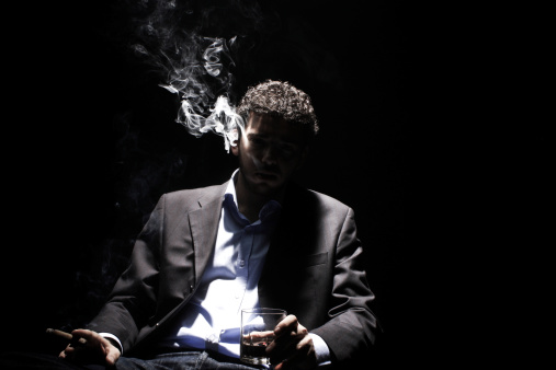 man is smoking cigar in darkness..SEE MORE RELATED IMAGES