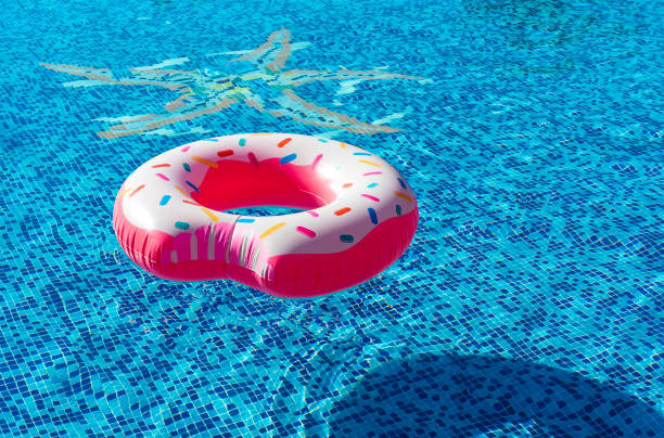 istock Pink inflatable donut swimming ring in a swimming pool 1823540402